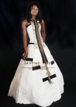 Shifting Sands Traditional African Xhosa inspired baige and black wedding dress with leather and feather detail